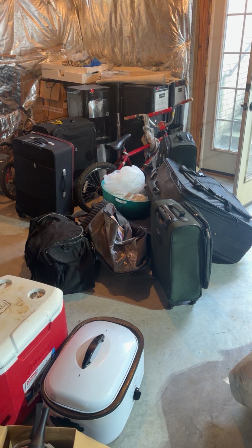 Garage packed with luggage and bags before cleanout