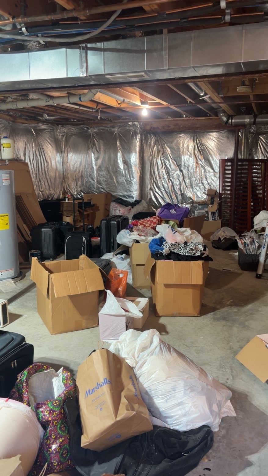 Basement full of boxes and luggage before cleanout