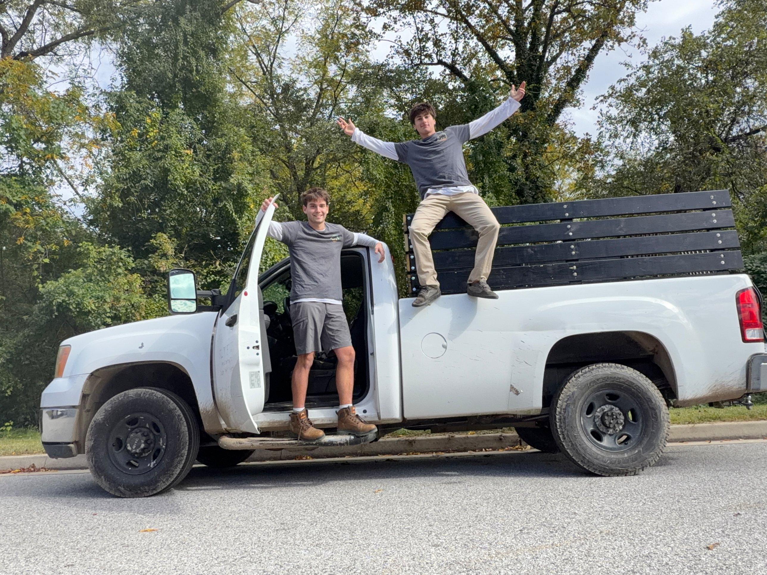 RJ's crew with a gas grill pickup, giving a thumbs up
