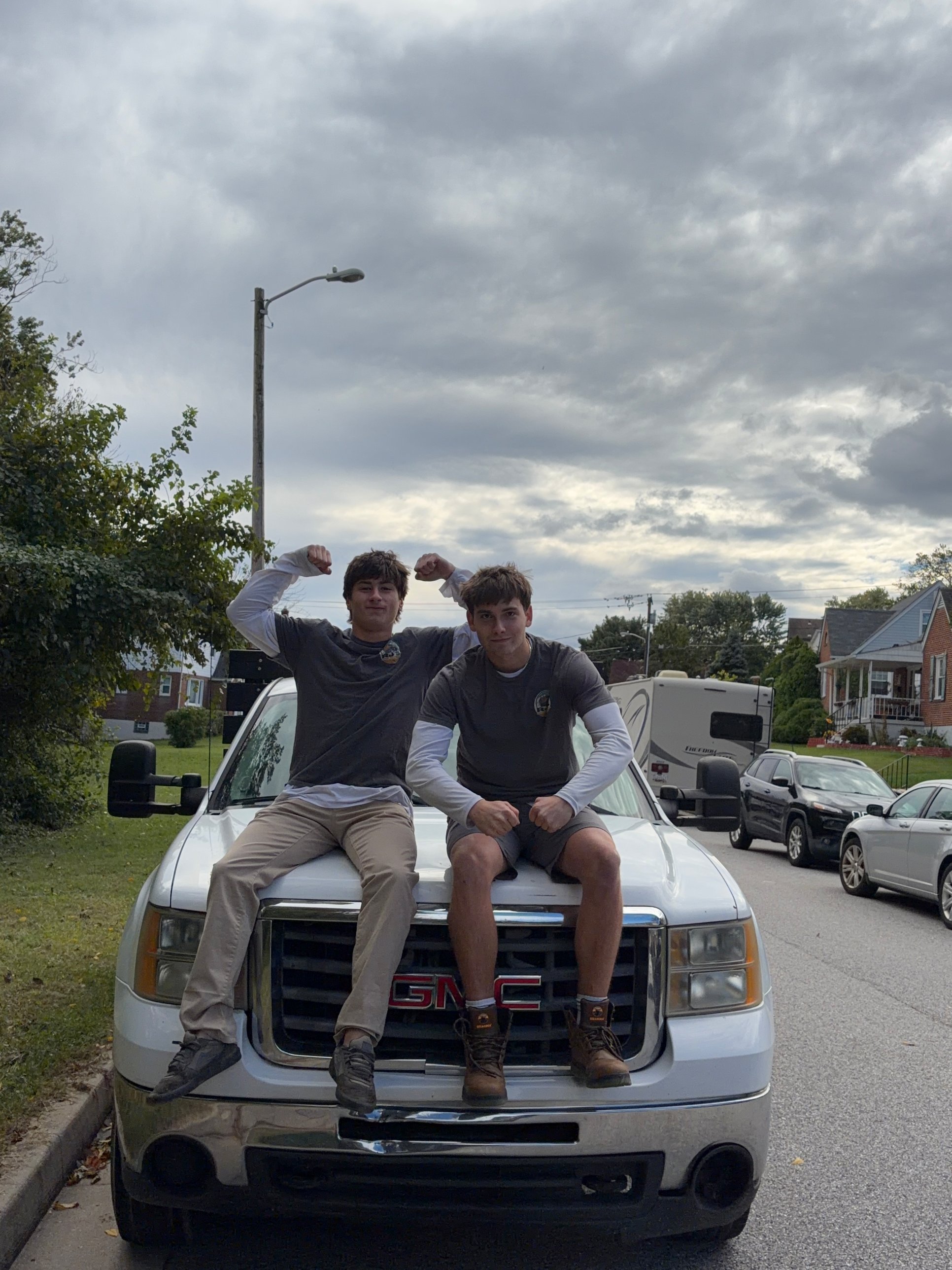 RJ's Junk Removal founders on the truck after a job