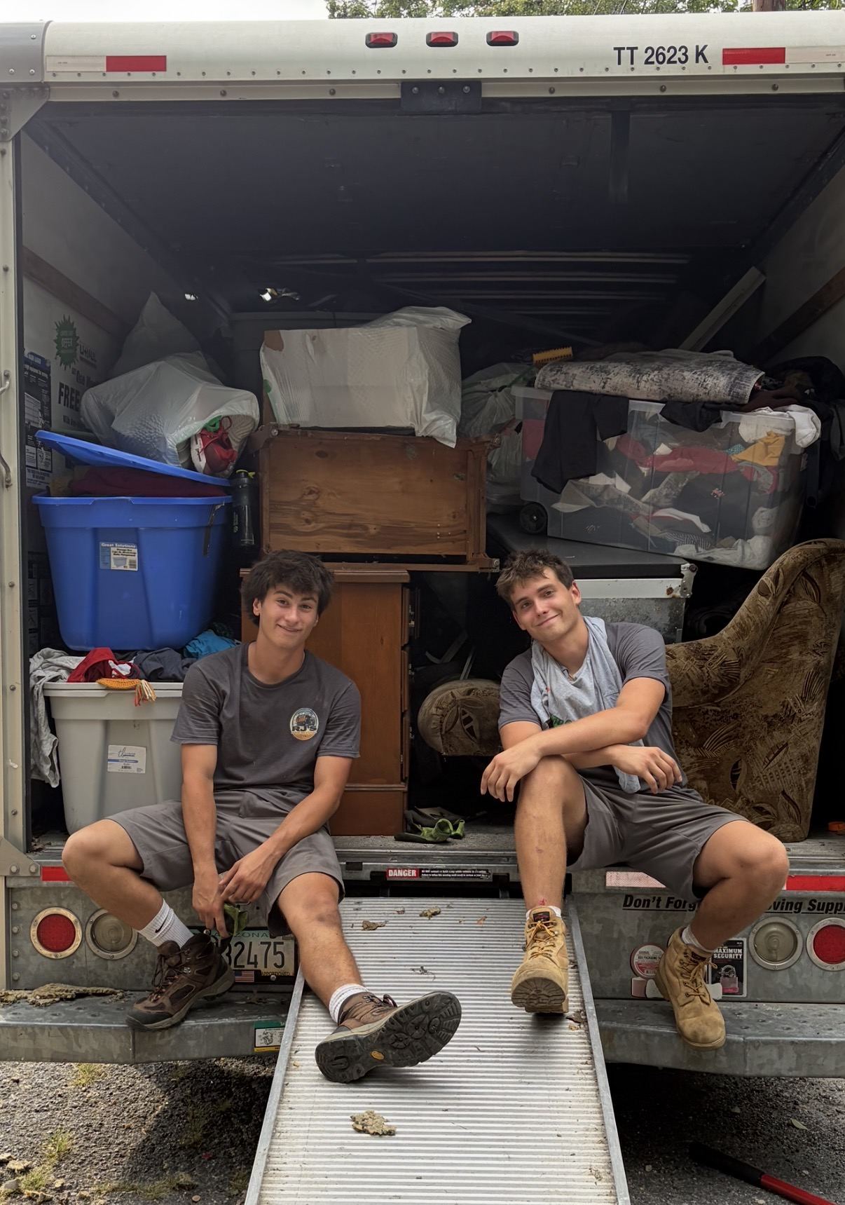 RJ's crew sitting on the ramp of a fully loaded truck
